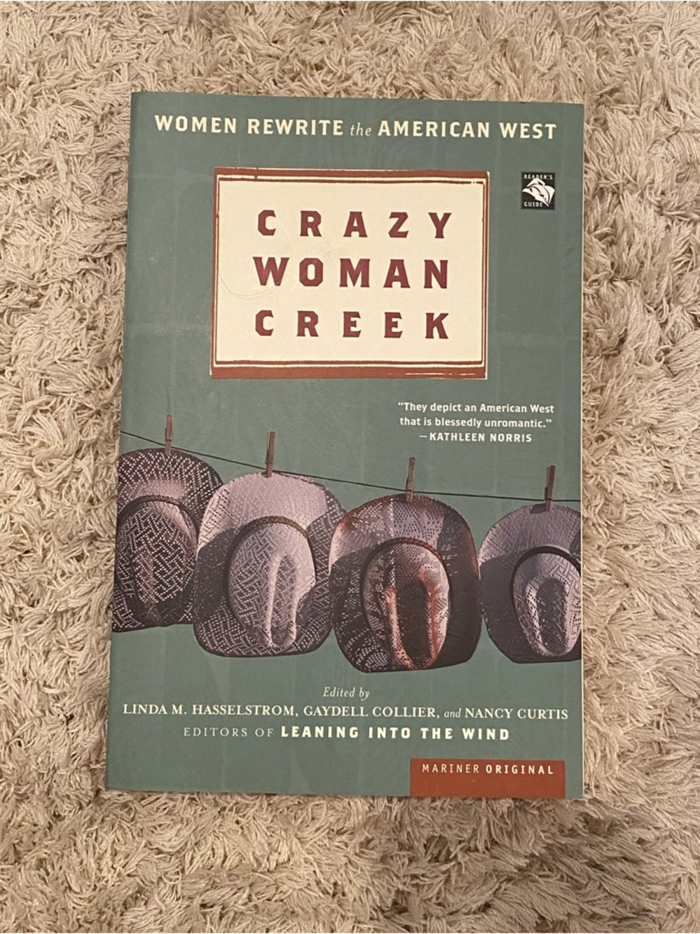 Crazy Woman Creek paperback book - teal cover with brown hats